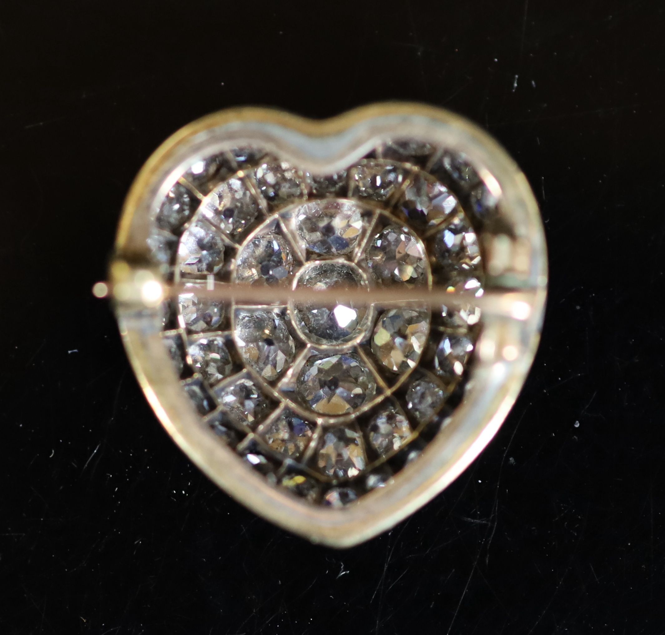 A Victorian gold, silver and pave set old mine cut diamond heart shaped brooch